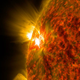 The bright flash of an M-class flare is seen exploding on the left side of the sun in this image from Nov. 5, 2014. (NASA)
